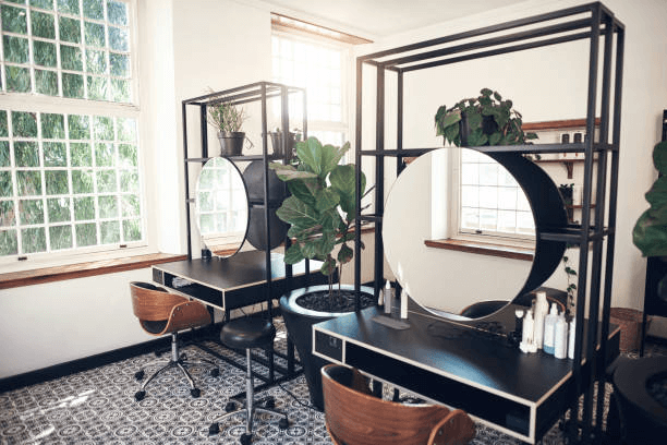 Two hair styling stations in an empty hair salon.